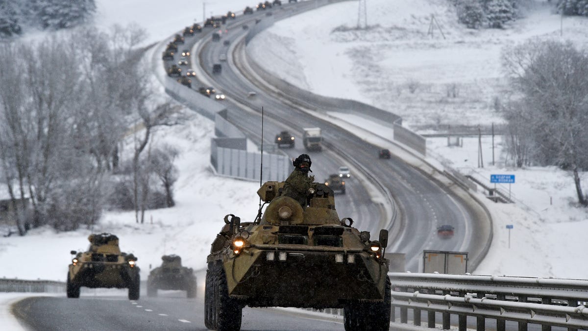 A convoy of Russian armored vehicles moves along a highway in Crimea, Tuesday, Jan. 18, 2022. Russia has concentrated an estimated 100,000 troops with tanks and other heavy weapons near Ukraine in what the West fears could be a prelude to an invasion.