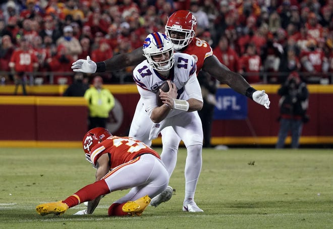 Bills quarterback Josh Allen tries to escape the Chiefs defense in Sunday's 42-36 loss in Kansas City.