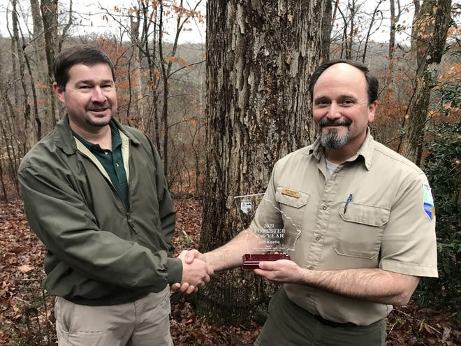 Keith Murphy of the Georgia Forestry Commission, left, congratulates Jeff Kastle of Athens as the 2021 Forester of the Year.
