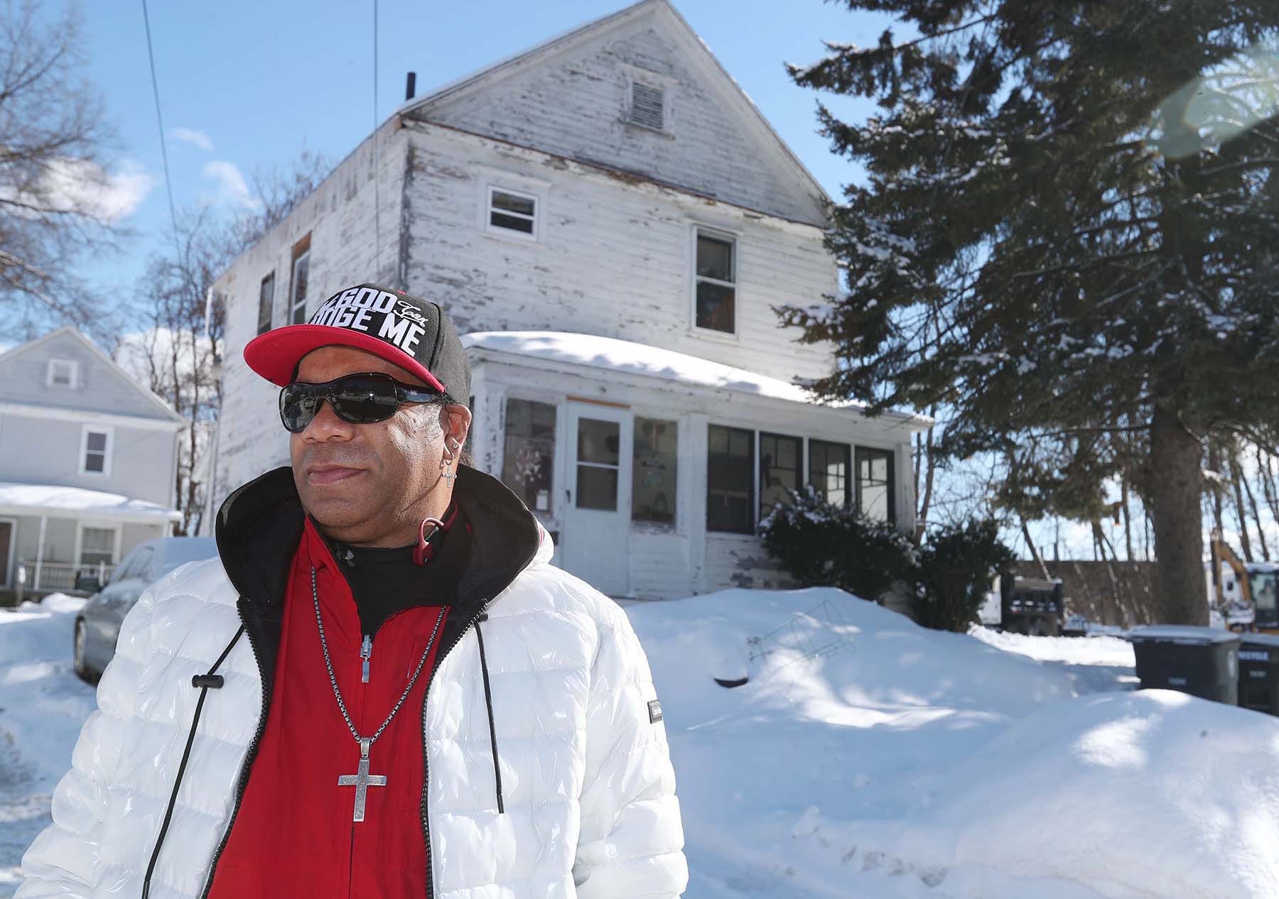 Willie Johnson stands in front of what used to be his family’s home at 533 Douglas St. in Akron. The Johnson family blames the construction of the Akron Innerbelt for its depreciation in value when they owned the house.