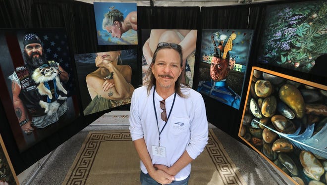 An artist displays his creations at a booth during a previous IMAGES Art Festival.