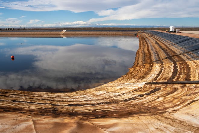 Oil stains mark water levels in a produced storage pond south of Malaga. The water here has been treated to remove much of the toxic residue from fracking, and is stored alongside a freshwater pond for mixing and re-use in fracking operations.