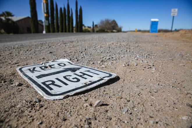 Loose gravel and a sign sit Elks Drive as road work takes place in Las Cruces on Wednesday, Jan. 26, 2022.