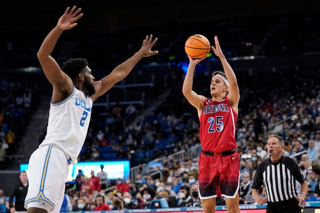 Arizona guard Kerr Kriisa, right, shoots as UCLA forward Cody Riley defends during the first half of an NCAA college basketball game Tuesday, Jan. 25, 2022, in Los Angeles. (AP Photo/Mark J. Terrill)