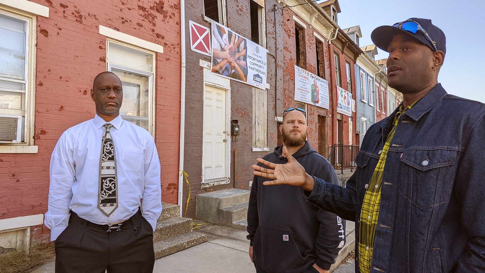 Fred Walker, left, and Anthony Moore, right, talk about plans for Tamra Langle's Salem Square home in front of the facade on Nov. 11, 2021. Cody Lighty, vice president of Four Square Construction, looks on at center. The facade, which was pulling away from the building, was later removed and will be rebuilt.