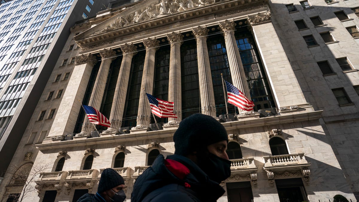 A pedestrian passes the New York Stock Exchange, Monday, Jan. 24, 2022, in New York.