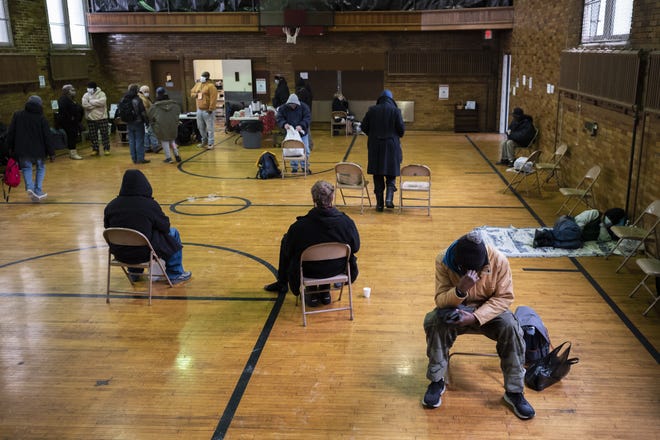 People who are homeless sit inside a warming station at Broad Street United Methodist Church in January. They were counted as part of a "point-in-time" tally of the homeless.