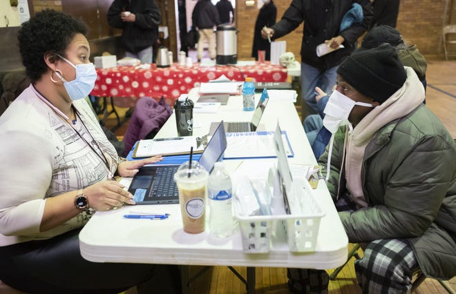 Angelique Ericson, left, with the Columbus Coalition for the Homeless, asks Antjuan Muhammad a set of survey questions at the Broad Street United Methodist Church as part of Community Shelter Board's annual count of homeless people in Franklin County.