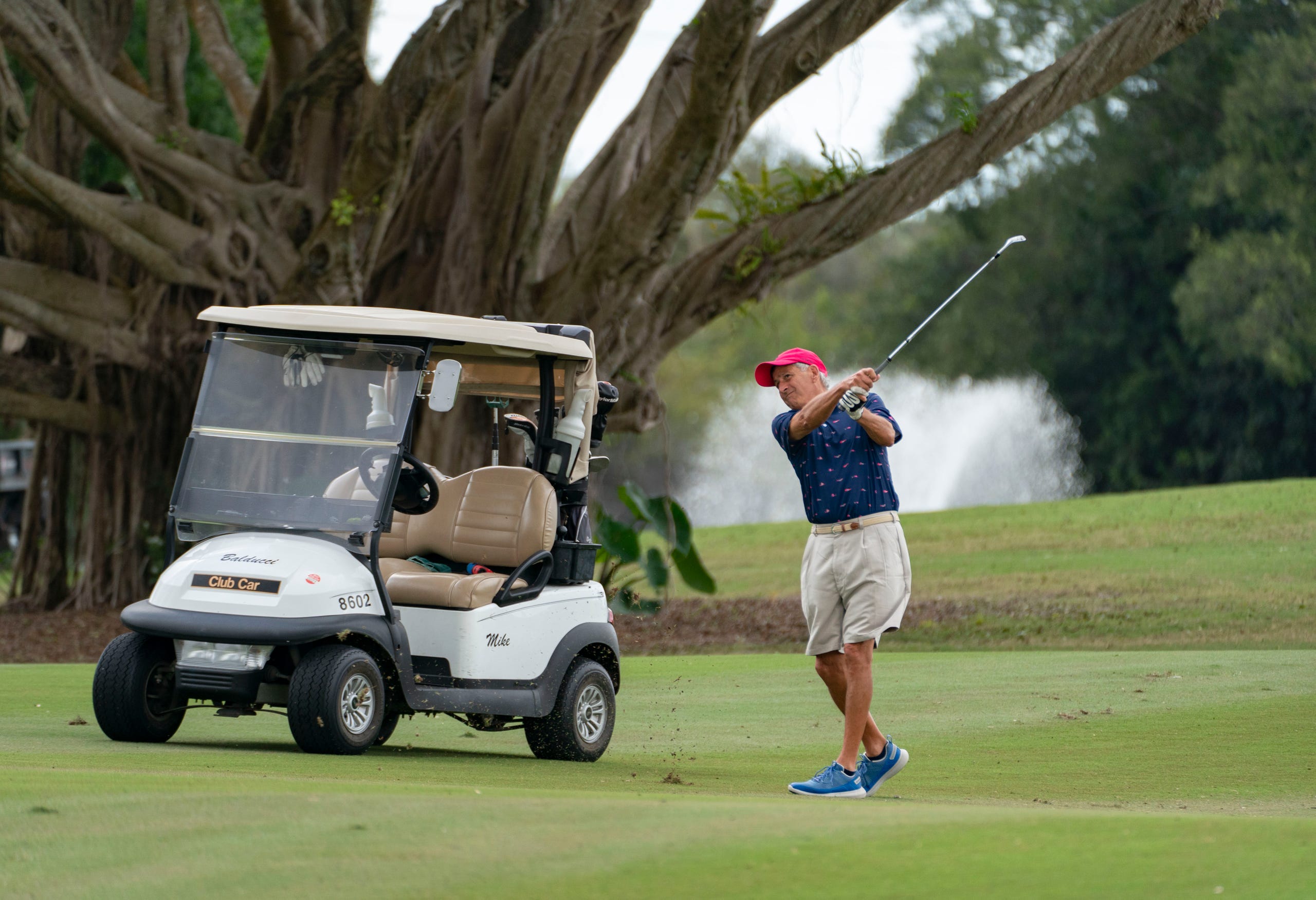Mike Balducci hits the ball from the fairway during a round of golf at BallenIsles Country Club in Palm Beach Gardens, Florida on January 27, 2022.