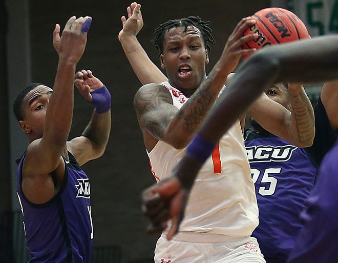 Texas-Rio Grande Valley's Justin Johnson (1) snags a rebound from Abilene Christian's Mahki Morris (12) and Immanuel Allen (25) during the Western Athletic Conference game Wednesday in Edinburg.