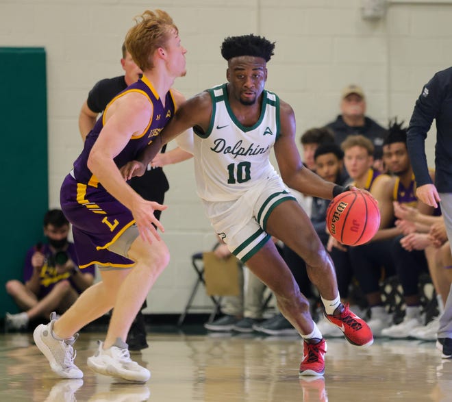 Gyasi Powell of Jacksonville University (10) drives on Lipscomb's Will Pruitt during Thursday's game at Swisher Gym. Powell scored 11 points in a 66-59 victory.