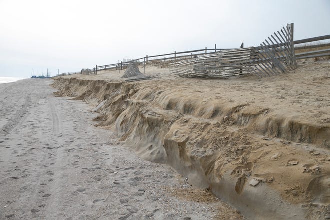 A Toms River police officer looks over the beach where severe erosion has been a problem. A portion of the beach has a 4-5â€™ drop-off where recently replenished sand has washed away.Ortley Beach, NJFriday, January 28, 2022 
