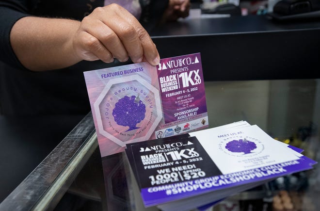 Owner Crystal Young shows flyers for BantuCola's Black Business Week at JoJo's Beauty Supply at 312 E. Nine Mile Road in Pensacola on Thursday. BantuCola, a platform dedicated to bringing awareness to Black businesses in Pensacola, will be holding its second annual Black Business Weekend at JoJo’s on Feb. 4 and 5.