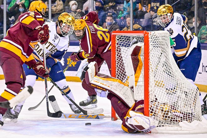 Notre Dame center Hunter Strand (11) attempts a shot on goal in the second period against Minnesota at the Compton Family Ice Arena Friday, Jan. 28, 2022, in South Bend.