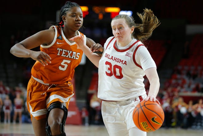 Oklahoma guard Taylor Robertson moves past Texas forward DeYona Gaston during their Big 12 matchup in Norman, Okla., on Jan. 29. The Sooners won 65-63. Oklahoma, which leads the Big 12 by one game, plays at Texas on Wednesday.