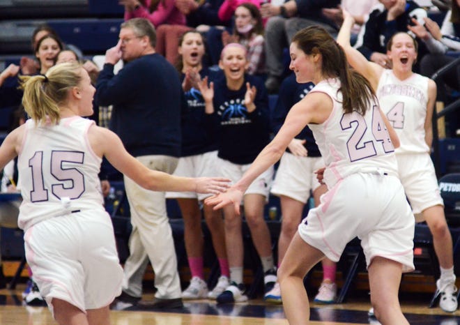 Petoskey's Caroline Guy (24) is congratulated by teammate Hayley Flynn (15) as she runs back on defense after her third 3-pointer of the first half Friday against Traverse City West.