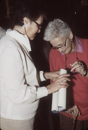 Mary Daniels Taylor, right, examines a historic document in the Durango cathedral archives, with help from Durango native Maria Teresa Dorador de Reyes. Taylor alerted the New Mexico State University Library Archives and Special Collections staff about the archive of the Archbishopric of Durango.