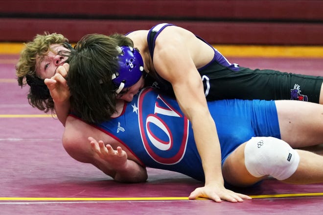 Bloomington South’s Cam Meier wrestles against Owen Valley’s Eli Collier in the 106-pound weight class during the IHSAA boys’ wrestling sectionals at North Saturday. Meier, a freshman, won 16-7.