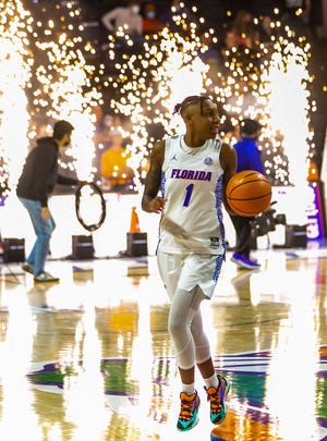 Gators guard Kiara Smith (1) comes onto the court as pyrotechnics explode behind her Sunday, Jan. 30, 2022 at Stephen C. O'Connell Center in Gainesville. She led the Gators in scoring in their first meeting with Auburn this season.