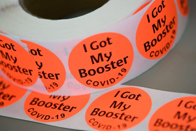 Stickers for COVID-19 vaccine booster shots at a vaccine clinic sponsored by New Direction Health Care Solutions at the John T. O'Connor Senior Center in Knoxville, Tennessee, will be on display on Saturday, January 29, 2022.
