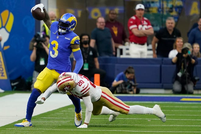 Los Angeles Rams wide receiver Odell Beckham Jr., left, tries to avoid the tackle of San Francisco 49ers' Ambry Thomas during the Rams' 20-17 win in the NFC Championship Game on Sunday. [Elaine Thompson/Associated Press]