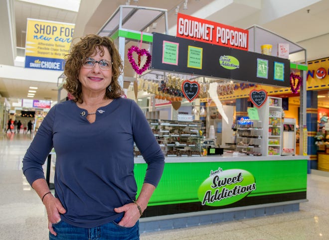 Jane Scott of Jane's Sweet Addictions poses outside her popular confectionery kiosk in the Northwoods Mall.