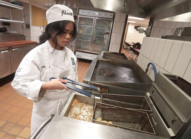 R.G. Drage culinary student Jhacel Dawa, of Louisville High School, fries chicken to make General Tso's chicken at the school on Monday. The Massillon school's student-operated Harvest Room Restaurant will open for the spring session on Thursday and Friday with a Chinese buffet.