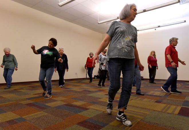 Sarah Brown steps forward as she practices with the rest of her line dancing class at the Abilene Public Library's Mockingbird Lane branch Jan. 27.