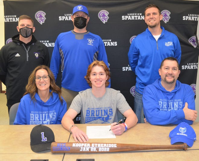 Lakeview senior Kooper Etheridge participates in a signing ceremony at Lakeview High School on Friday. He will play for Kellogg Community College next year. He is joined by his parents and coaches.