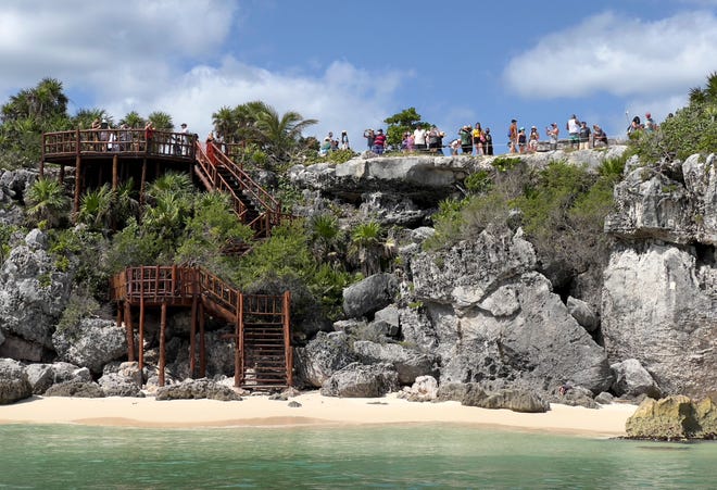 People visit the pre-Columbian Mayan archaeological site of Tulum on October 30, 2021.