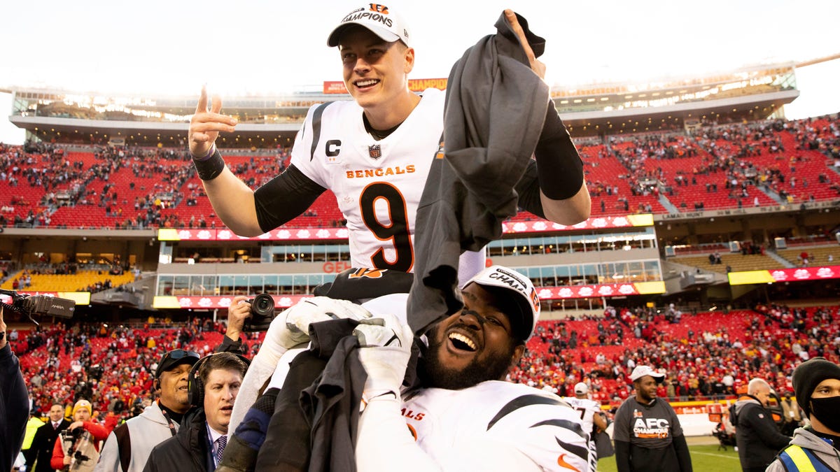 Bengals defensive tackle Tyler Shelvin lifts up Joe Burrow after winning the AFC championship game Sunday in Kansas City.
