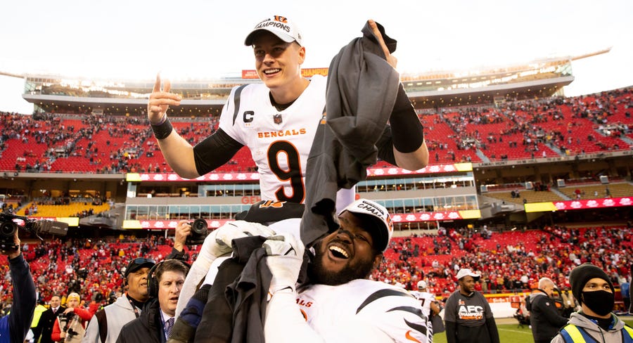 Bengals defensive tackle Tyler Shelvin lifts up Joe Burrow after winning the AFC championship game Sunday in Kansas City.