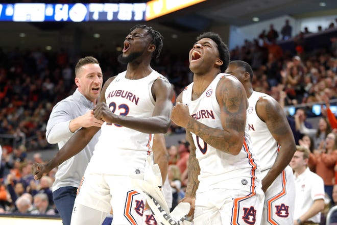 Auburn center Babatunde Akingbola (23) and guard K.D. Johnson (0) react after a play against Oklahoma during the second half at Auburn Arena.