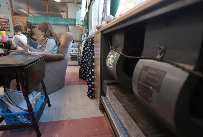 Taft Elementary school second grader Emma Albu reads in class near the school's air ventilation system. Plain Local is among the roughly dozen local school districts that have recently upgraded its ventilation system in an effort to prevent the spread of the coronavirus.