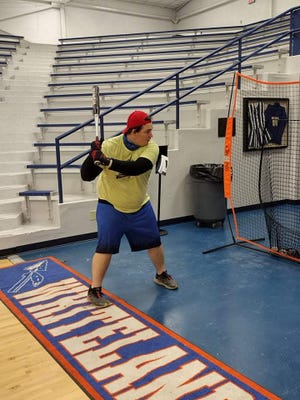 Devin New of Bedford takes batting practice during a Team Indiana softball team practice Sunday at Whiteland High School. New is the first Lawrence County Special Olympian chosen for Team Indiana.
