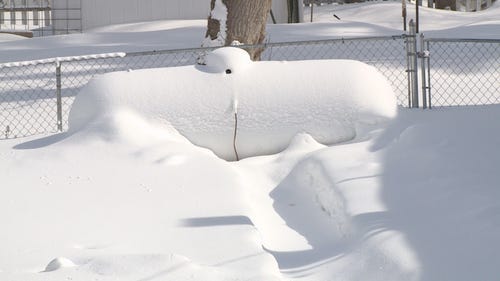 A snow-covered propane tank.