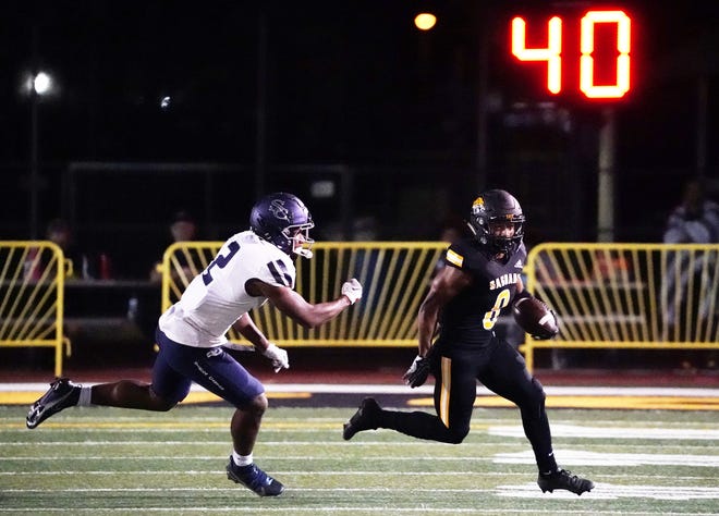 Oct 15, 2021; Scottsdale, Arizona, USA; Saguaro Sabercats wide receiver Javen Jacobs (8) is chased by Sierra Canyon (CA) Trailblazers Khalil Peart (2) at Saguaro High School.