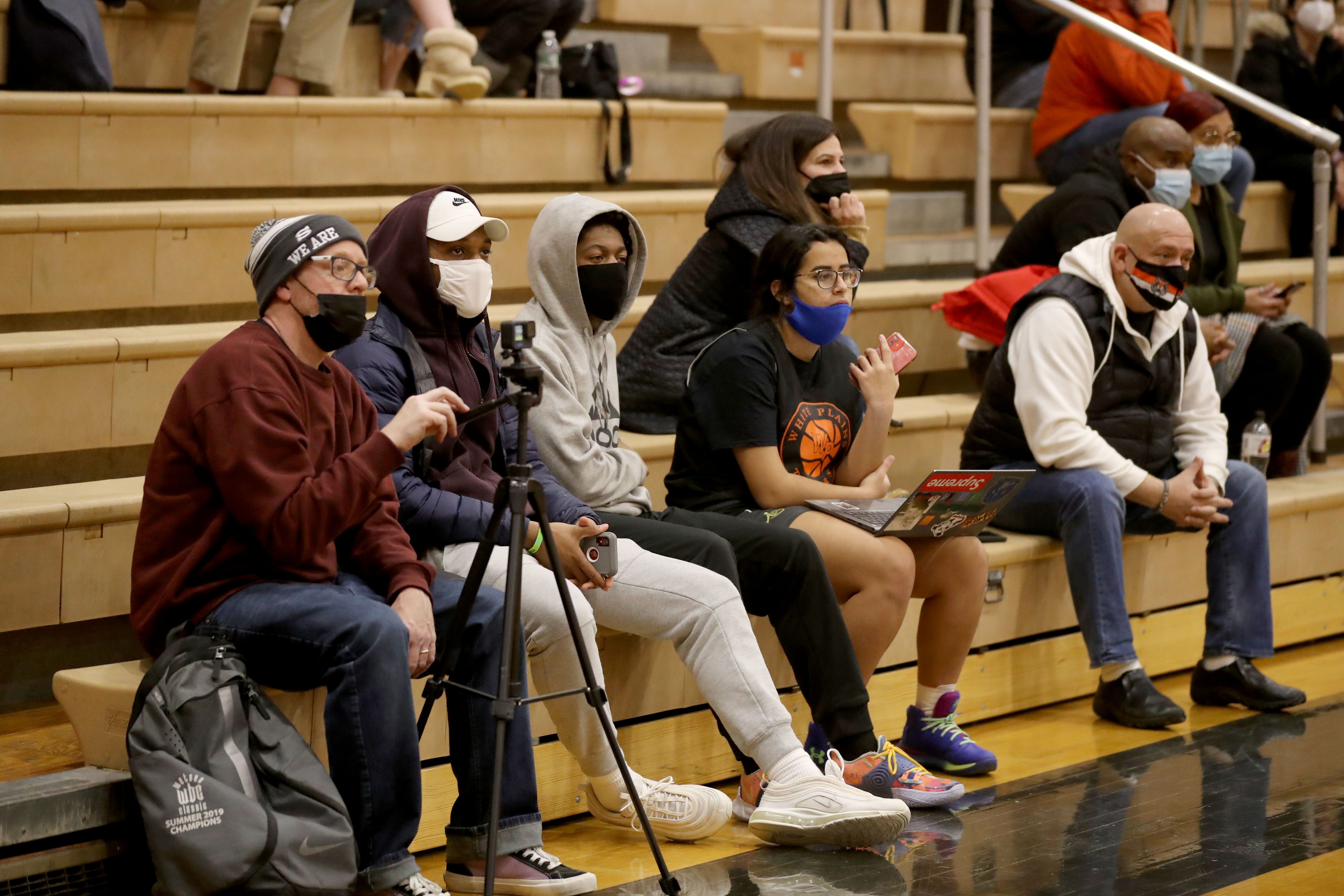 Fans wear masks in New York as they attend a girls basketball game between Scarsdale and White Plains at White Plains High School Jan. 31, 2022.