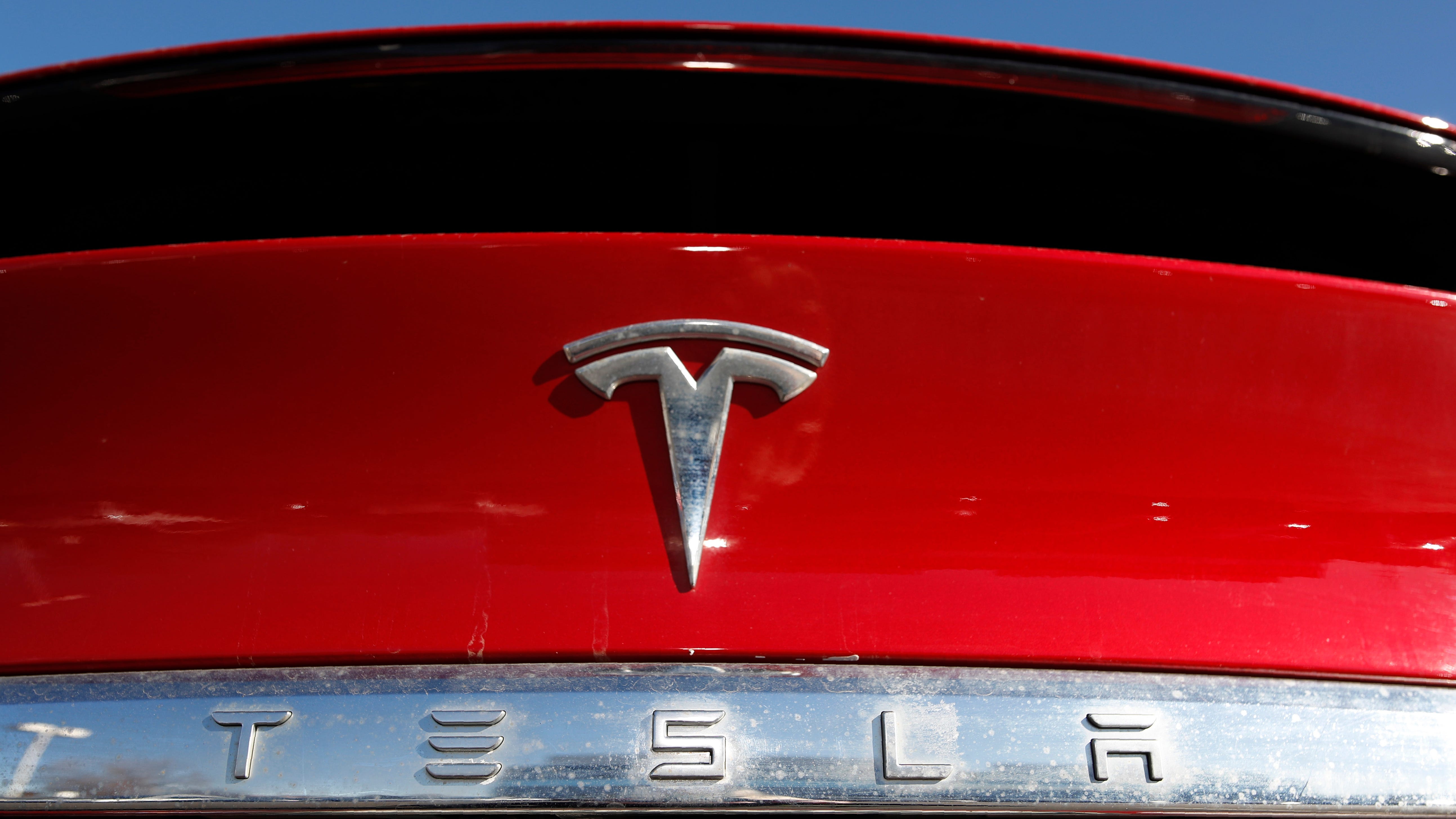 In this Feb. 2, 2020 file photo, the company logo sits on an unsold 2020 Model X at a Tesla dealership in Littleton, Colo.
