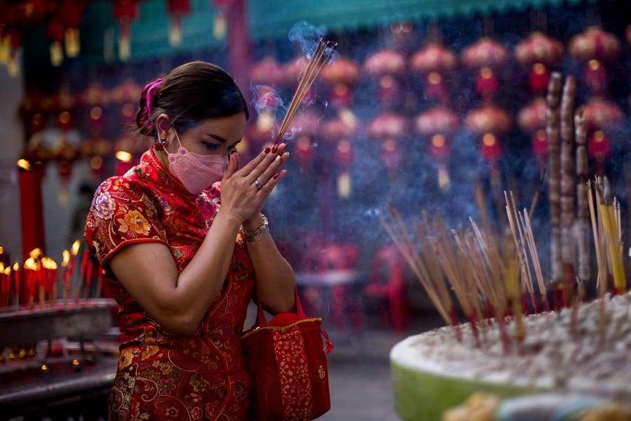 A woman prays at a shrine to mark the start of the Lunar New Year of the Tiger in Bangkok on Feb. 1, 2022.