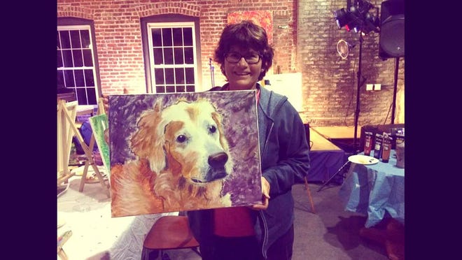 Susan Gabrielson with the portrait she painted of her dog Lily, who passed at the age of 14 this past October. She now has a painting of her pet that she did herself and will cherish forever.