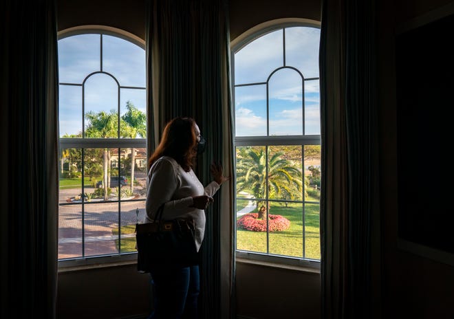  Ann Grenci looks out the window of a home for sale in Bay Hill Estates as she and her husband look for a new home in Palm Beach Gardens, Florida on January 28, 2022.