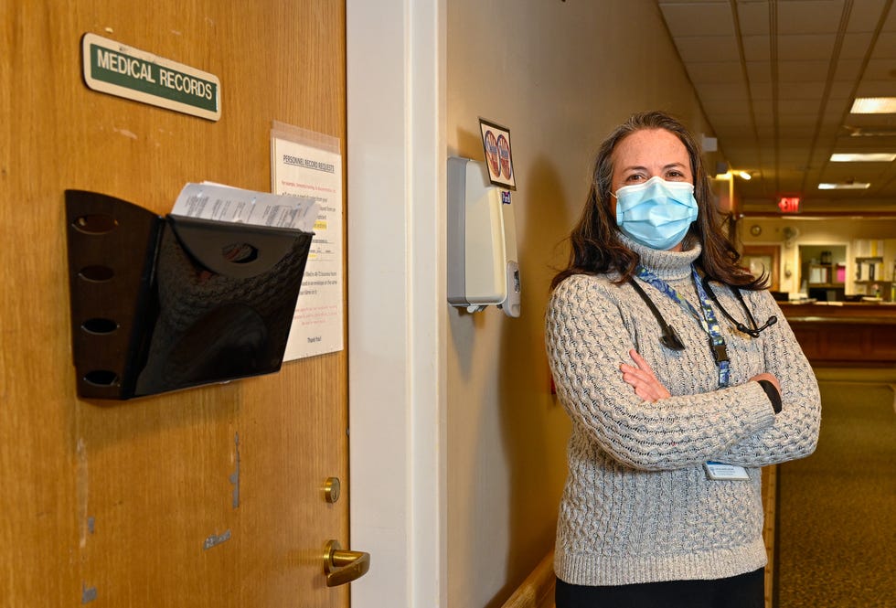 Dr. Larissa Lucas poses for a photo near the medical records room at the Rosewood Nursing and Rehabilitation Center in Peabody, MA on Tuesday, Feb. 1, 2022.