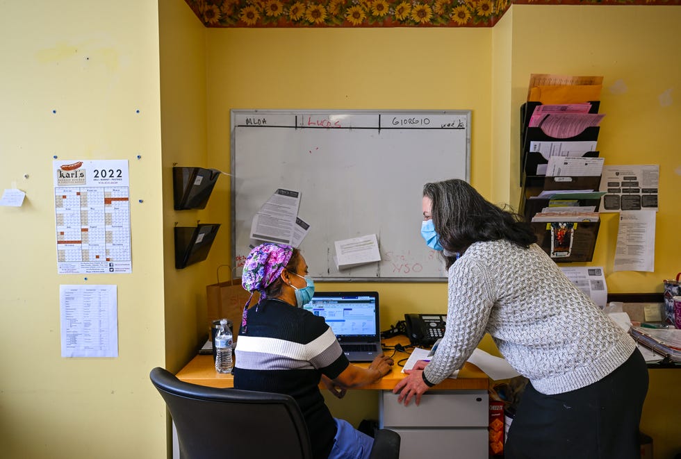Sheela Kaithamattam, left, geriatric nurse practitioner, talks with Dr. Larissa Lucas, right, inside the medical records room at the Rosewood Nursing and Rehabilitation Center in Peabody, MA on Tuesday, Feb. 1, 2022.