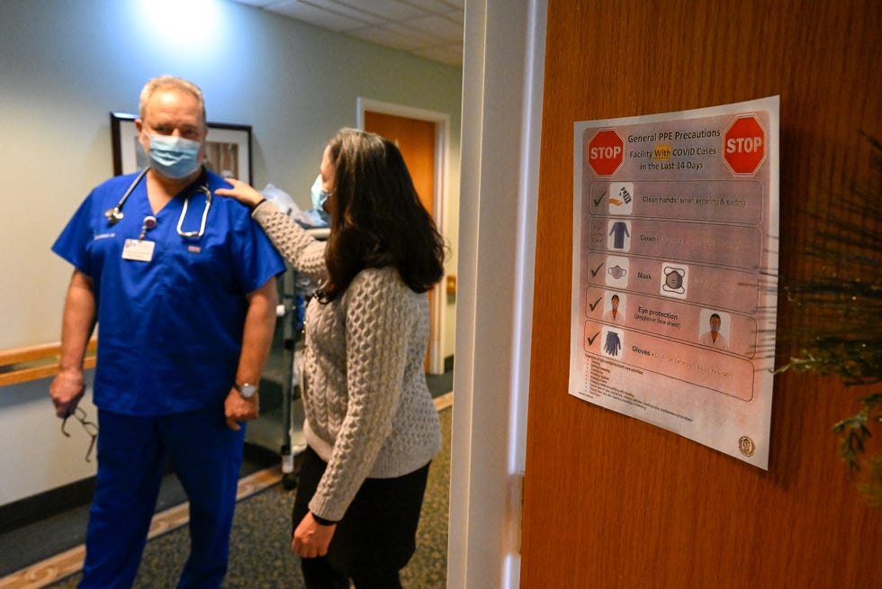 Oleksandr Barchuk, nurse practitioner, talks with Dr. Larissa Lucas outside one of the resident rooms the Rosewood Nursing and Rehabilitation Center in Peabody, MA on Tuesday, Feb. 1, 2022.