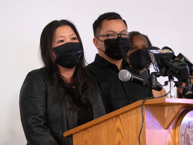 AN OX Cafe owners Sia Xiong, left, and husband Johnni Sihavong speak during the the grand opening at AN OX Cafe on West Hampton Avenue in Milwaukee on Feb. 2.