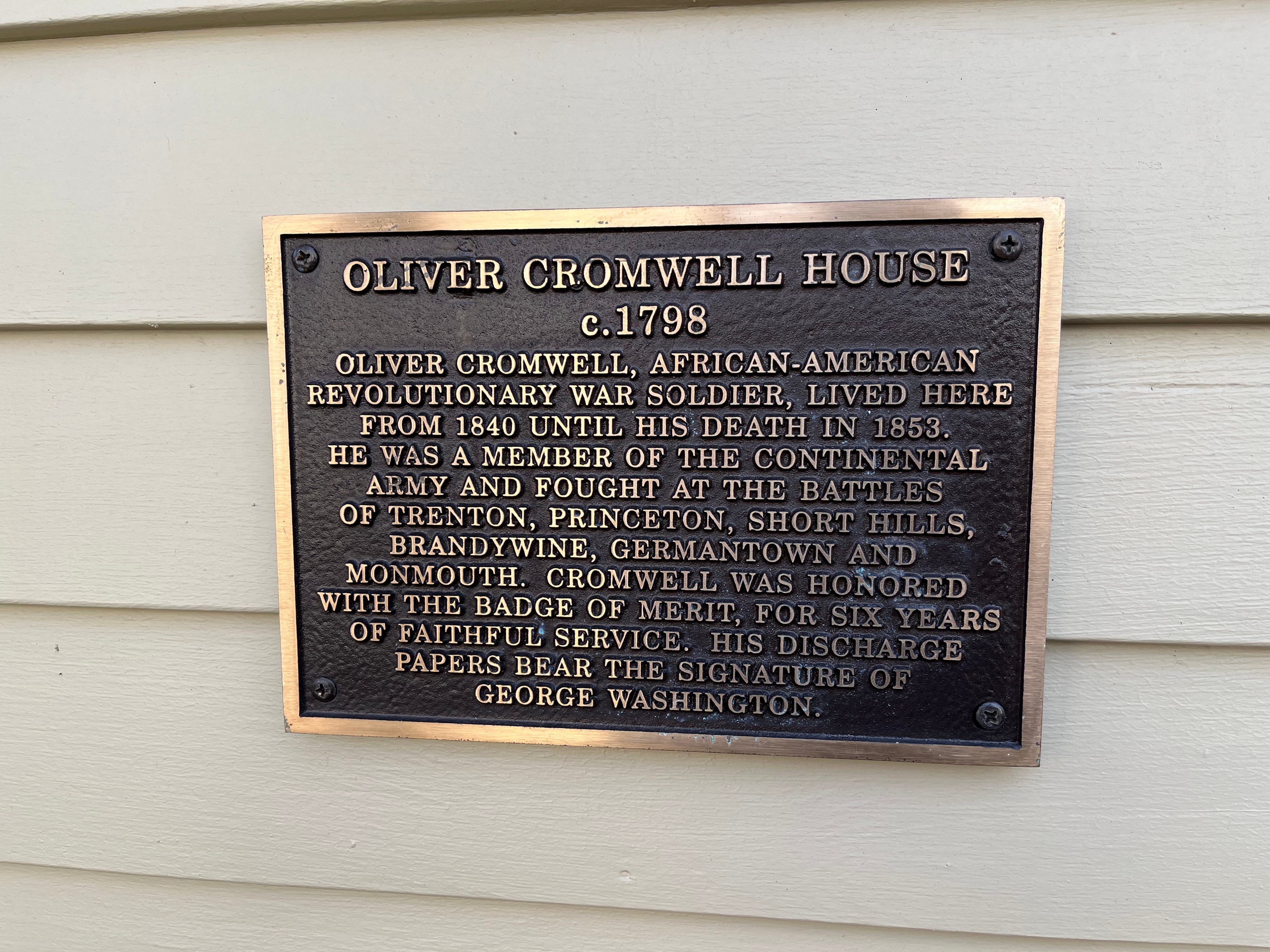 An unofficial historical plaque affixed to the former home of Olvier Cromwell at 114 East Union Street in Burlington, New Jersey, installed by owner Harry Heck. Until 2022, this had been the only historical monument to the Revolutionary War soldier.