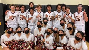 The Oxnard High boys basketball team pose with the school's cheerleaders after defeating Pacifica on Wednesday night to clinch the Pacific View League title.