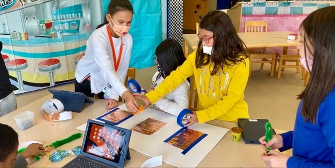 Fourth-graders from School No. 4 in Linden work on building their Read-O-Matic for the STEAM Tank Challenge, a statewide engineering competition. From left are Heidy Yanes, Andrea Rivas, Izabelle Rivera and Eva Dien.