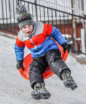 Luke Marks gets air while sledding at Butler University on Friday, Feb. 4, 2022, in Indianapolis. 